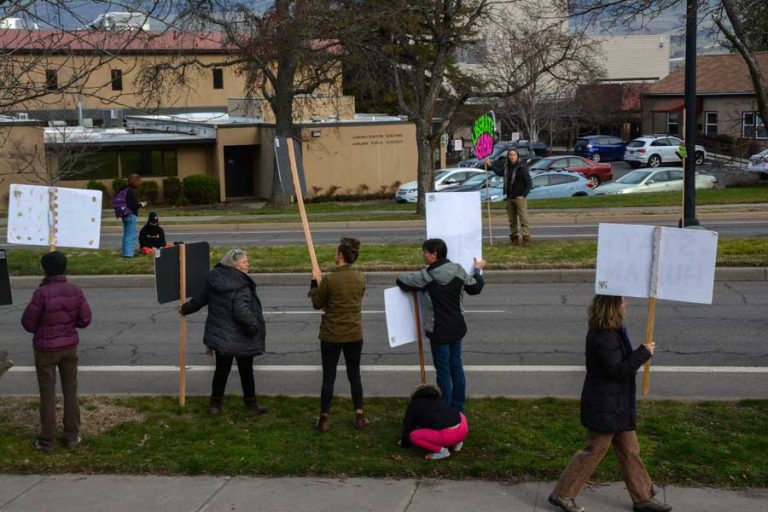 Anti-vaccination demonstrators picket across Siskiyou Boulevard from Ashland High School and the Ashland School District office on Tuesday after the district announced the school would move some students to distance learning for two weeks. Drew Fleming photo ashland high school goes online