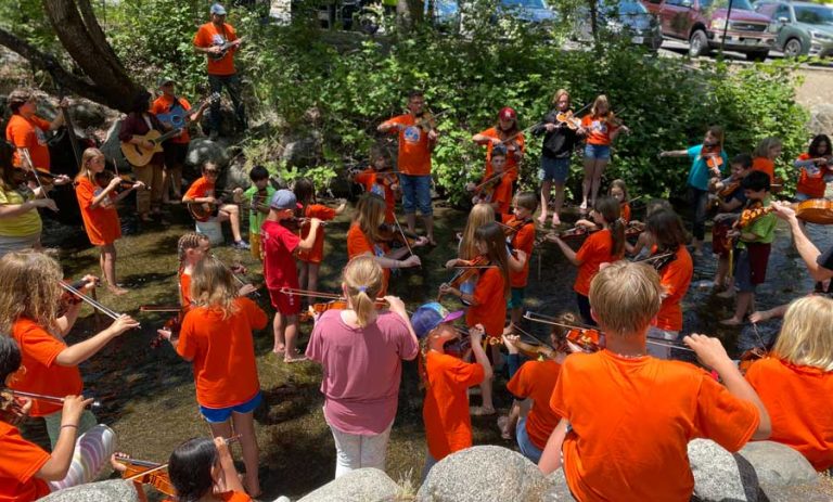 Fiddle Quest Camp players cool their heels — and soles — in Ashland Creek. Ashland.news photo by Holly Dillemuth