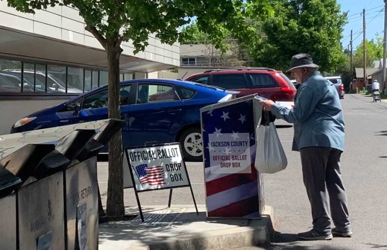 A voter drops his ballot in the drop box behind the Ashland Public Library during the May 2022 primary election. Ashland.news photo by Bert Etling