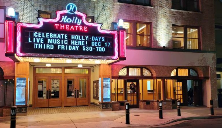 In this shot from 2021, the Holly Theatre was all dressed up for some outdoor holiday music performances under the marquee. Restoration of the iconic venue is resuming this year.