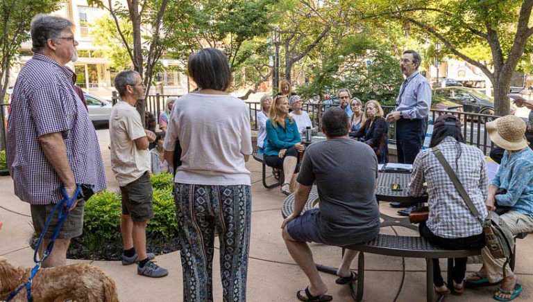 City Manager Joe Lessard (standing, center right) answers a question at the city’s coffee and conversation session Tuesday morning. Many people came to ask questions and make their points known to the city manager and the two city councilors who attended. Bob Palermini photo