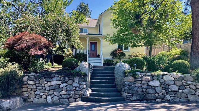 Trees and stone frame the front entry of the Holly Street home of Kathy and Stephen French. Larry Rosengren photo July Garden of the Month Ashland