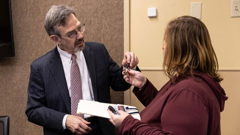 Outgoing Ashland City Manager Joe Lessard (left) turns over his ID and keys to interim HR Director Molly Taylor Friday evening. Ashland.news photo by Bob Palermini