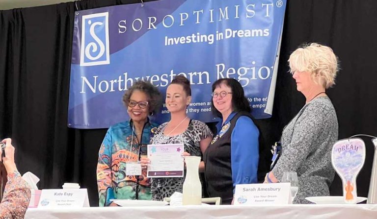 Sara Amesbury, holding certificate, receives her Live Your Dream award at the Soroptimist Northwestern Region meeting. Soroptimist photo