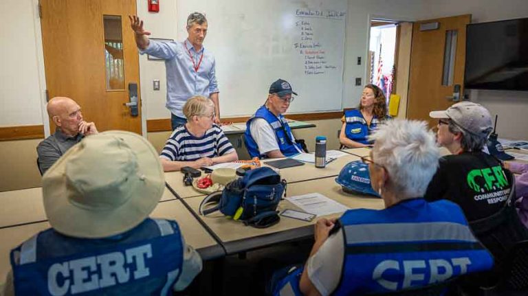 Ashland Emergency Management Coordinator Kelly Burns explains the training scenario to CERT volunteers before sending them out on the streets of evacuation Zone 8, the Railroad District, to survey the area and talk to residents. Ashland.news photo by Bob Palermini