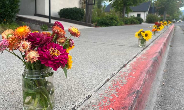 Flower arrangements line the streets of Talent, a symbol of hope and new life after the devastation of the Almeda Fire. Kayla Heffner photo for Ashland.news