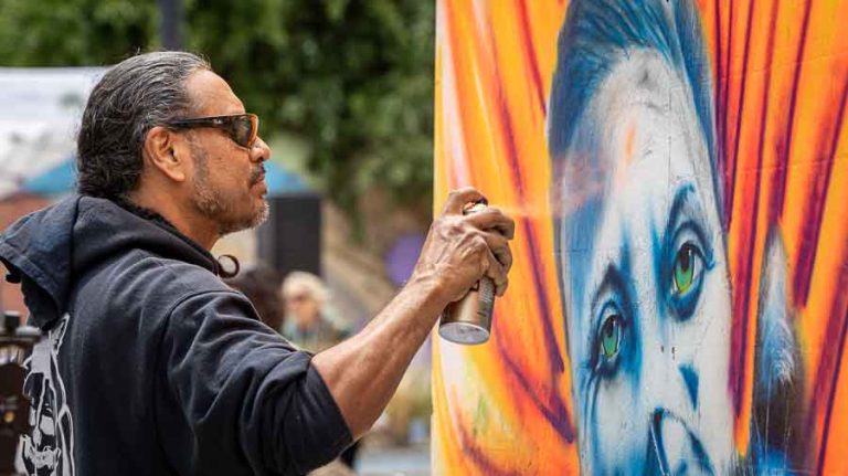 Gabriel Barrera, Ashland, works on his first Mural Fest mural Saturday afternoon. Ashland.news photo by Bob Palermini