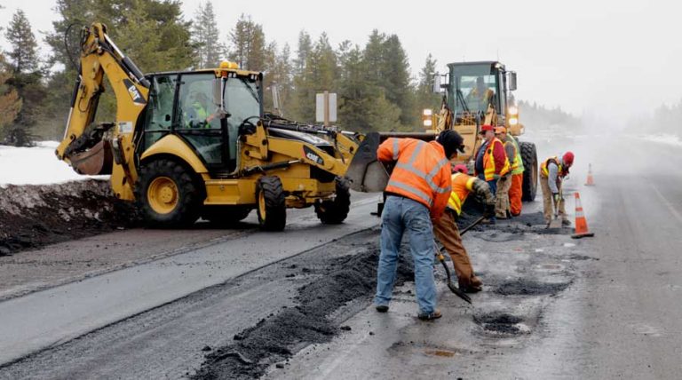 Oregon Department of Transportation workers fill a pothole on U.S. Highway 97 near Chemult in 2016. Gov. Tina Kotek announced Tuesday that she ordered lawmakers back to the Capital to address the Oregon Department of Transportation's $350 million budget shortfall. Oregon Department of Transportation photo via Flickr