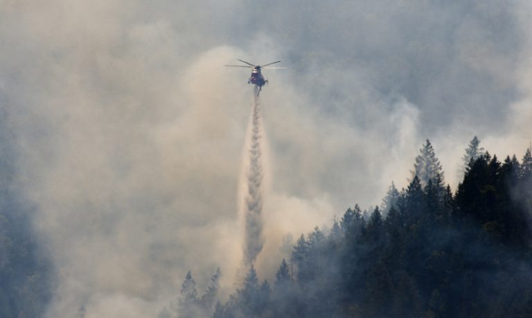 An Oregon Department of Forestry helicopter dumps water on a lightning-caused fire on Thursday, July 10, south of Ashland. Photo courtesy of Tanja Musselman/Tanja Musselman Photography, Carson City, Nevada