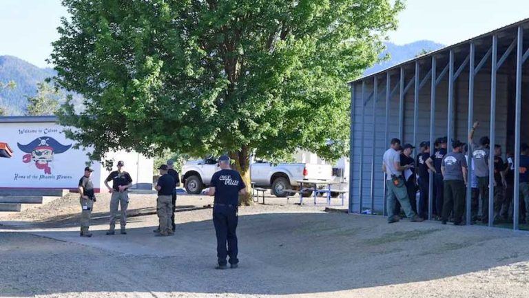 Fire crews meet for a 6 p.m. briefing Saturday at a fire "spike camp" set up on Phoenix-Talent School District property on Colver Road. Photo by Buffy Pollock for the Rogue Valley Times