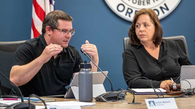 Ashland City Councilor Dylan Bloom, at left, asks questions about proposed pay raises and their effect on the city’s newly approved budget as Mayor Tonya Graham looks on. Ashland.news photo by Bob Palermini