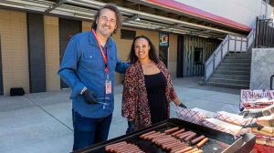 Ashland High School Interim Principal Francisco Lopez Atanes and Assistant Principal Becca Laroi grill hot dogs for teachers and staff Wednesday, a few days before school begins Monday. Ashland.news photo by Bob Palermini