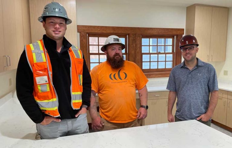 From left, Outlier project manager Ryan De Mello, Outlier construction supervisor Jeff Ross, and city project manager Eric Bingham in Pioneer Hall’s new kitchen. Pioneer Hall reconstruction is finished. Julia Sommer photo