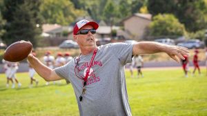New Ashland High School head coach Greg White throws with quarterbacks during practice Tuesday. Ashland.news photo by Bob Palermini