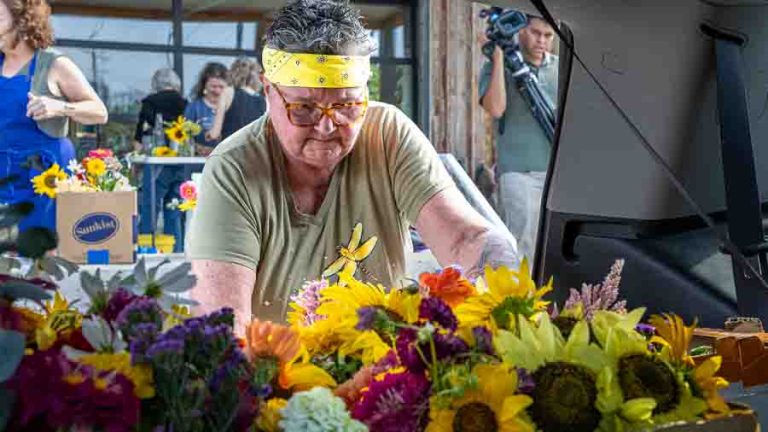 Organizer Cheryl Lashley loads flower arrangements in her vehicle for distribution around Talent. Ashland.news photo by Bob Palermini