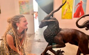 Liza Hamilton with her bronze sculpture "Momentum" on display at the Langford Art Gallery through Friday, Sept. 26. Kayla Heffner photo for Ashland.news